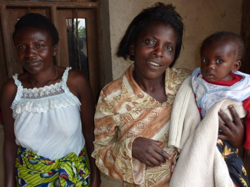 Mama Dorcas with an orphan and a helper