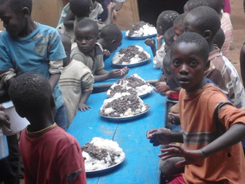 Enjoying the goat and a good source of protein.  Meat is a rare treat for the orphans